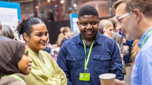 Staff and supporters engaged in conversation during a coffee break